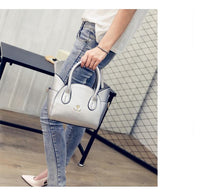 Silberne Handtasche in Katzenform, Damenmode, Lederoptik, stilvoll und modern.