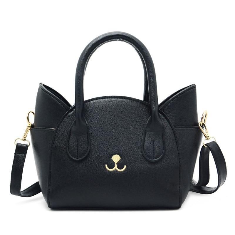 Schwarze Damenhandtasche aus Leder mit Katzendesign, goldene Details, abnehmbarer Schulterriemen.