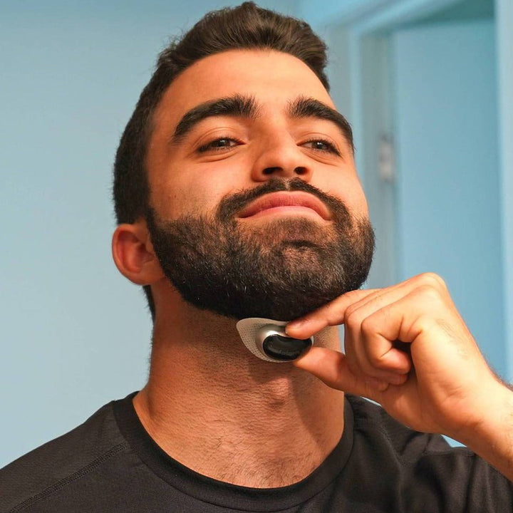 Mann verwendet schwarzen Rasierer auf Bart, Nahaufnahme, Badezimmer, Pflege, Rasur, männlich.