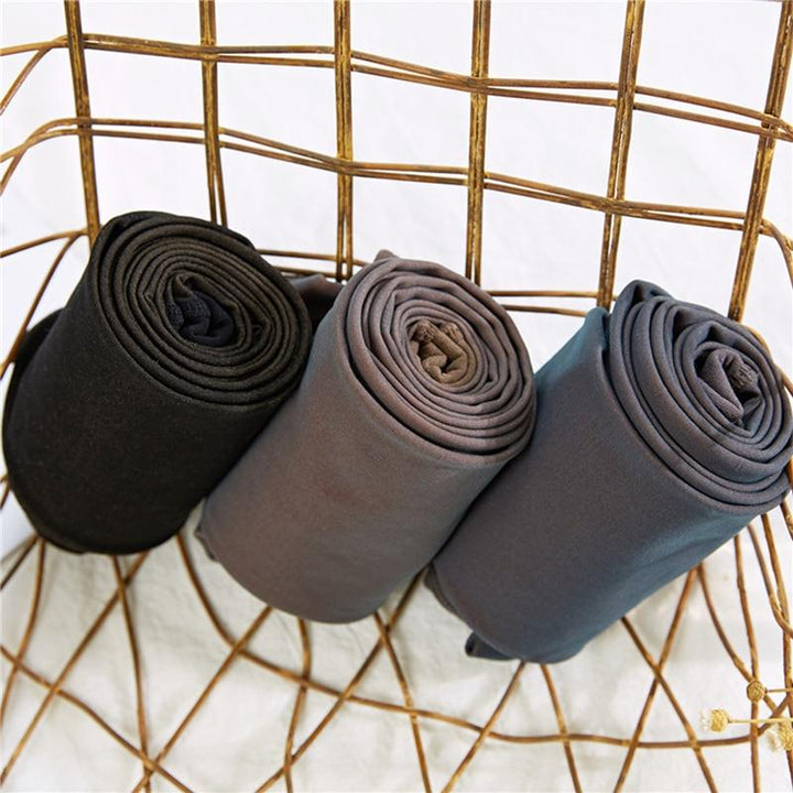 Drei Paar extra warme Leggings, schwarz, grau, blau, auf Drahtkorb, Wintermode, Einheitsgröße.