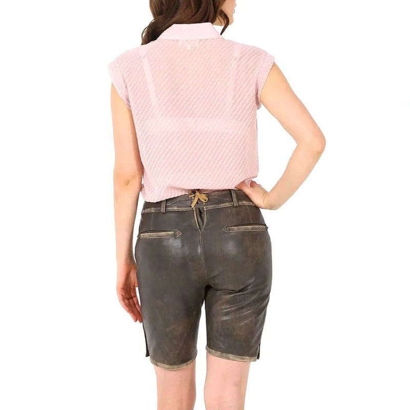 Frau in rosa Bluse und brauner Lederhose von hinten, Trachtenmode, traditionell, elegant.