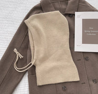 Beige Strick-Balaclava auf braunem Mantel, Frühling-Sommer-Kollektion, modisch, warm.