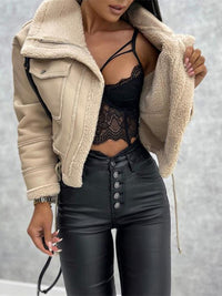 Damenmode: Beige Teddyfell-Jacke, schwarzes Spitzenoberteil, schwarze Lederhose.